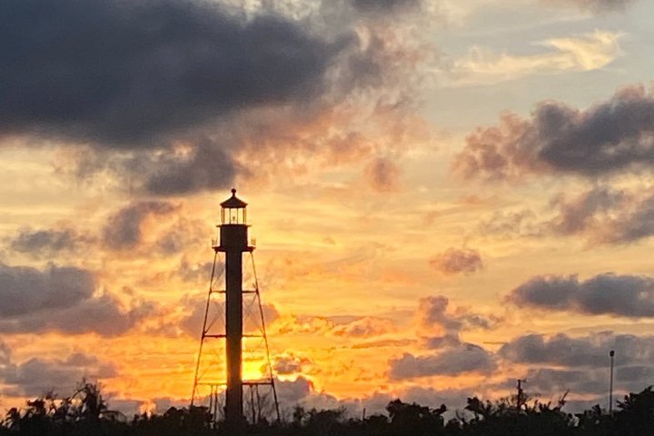 a group of clouds in the sky over a body of water