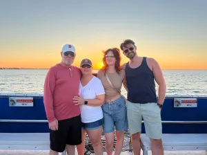 a group of people standing next to a body of water
