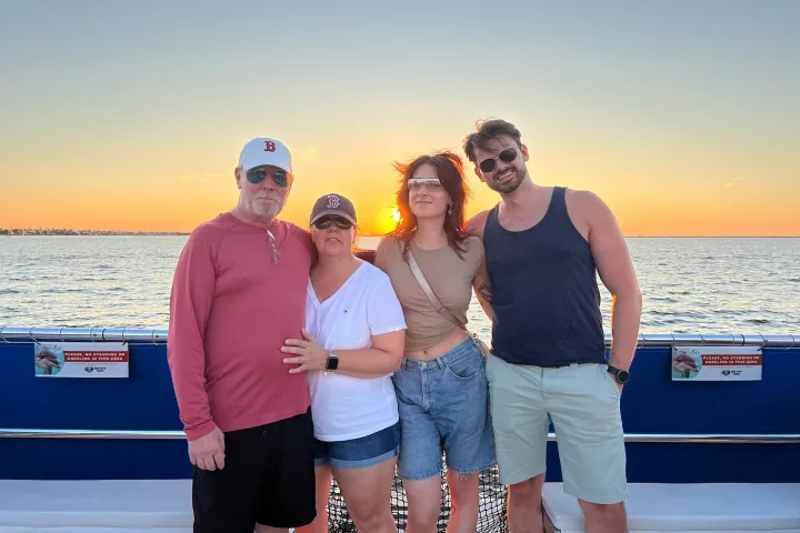 a group of people standing next to a body of water