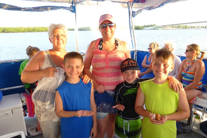 a group of people standing next to a body of water
